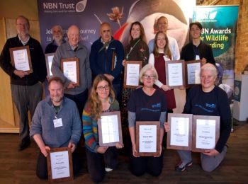 Group photo of 12 of the NBN award winners for 2024, holding their certificates